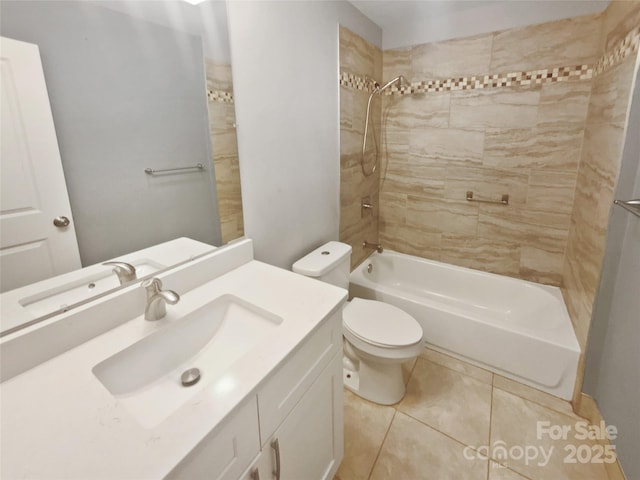 full bathroom featuring tile patterned flooring, vanity, tiled shower / bath combo, and toilet