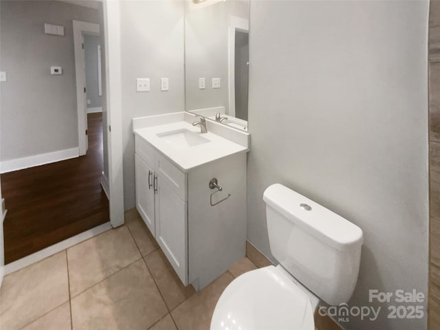 bathroom with vanity, toilet, and tile patterned flooring