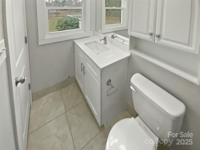 bathroom featuring tile patterned flooring, vanity, and toilet