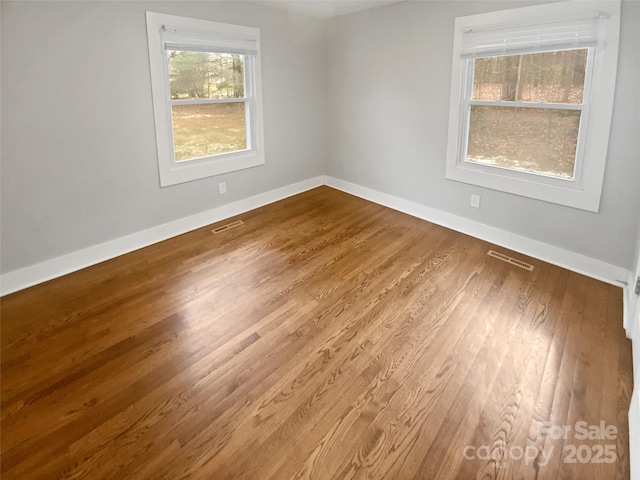 unfurnished room featuring hardwood / wood-style floors