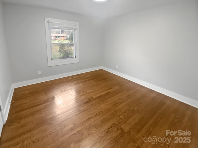 spare room featuring hardwood / wood-style floors