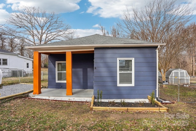 back of house with an outdoor structure