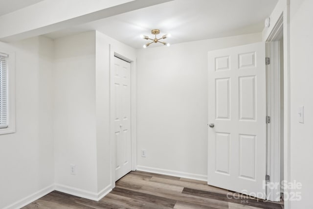 interior space with hardwood / wood-style flooring and an inviting chandelier