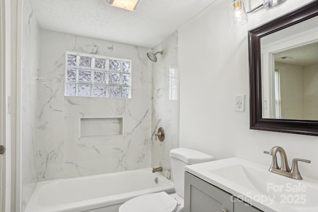 full bathroom with vanity, toilet, a textured ceiling, and tiled shower / bath