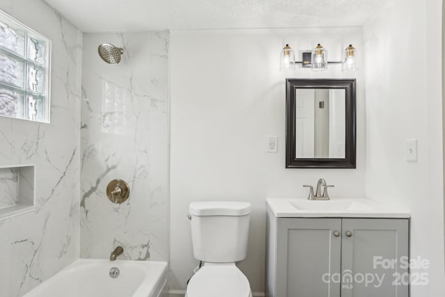 full bathroom featuring tiled shower / bath, vanity, and toilet