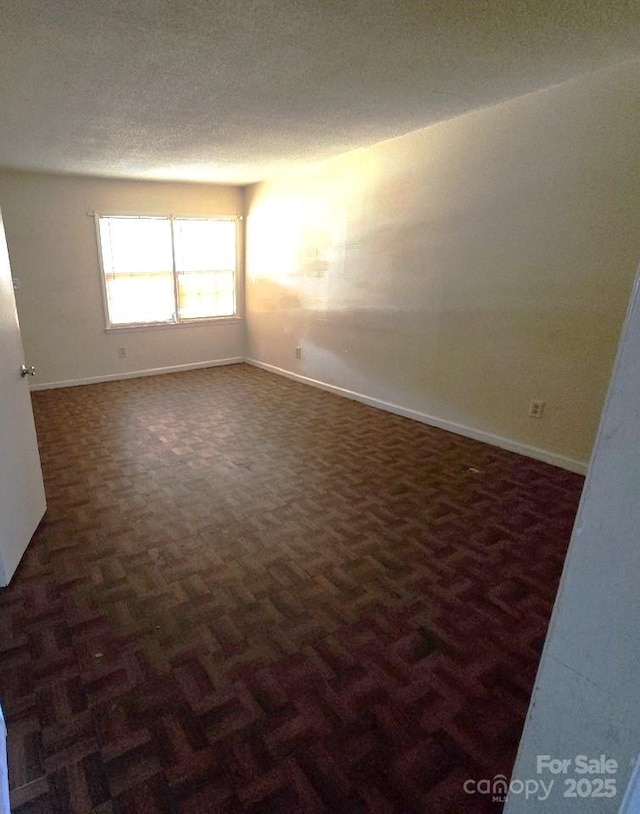 unfurnished room featuring dark parquet floors