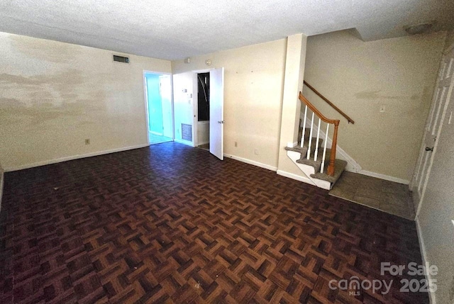 unfurnished room featuring dark parquet flooring