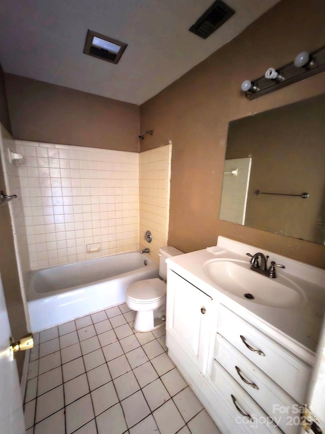 full bathroom with vanity, tile patterned floors, toilet, and tiled shower / bath