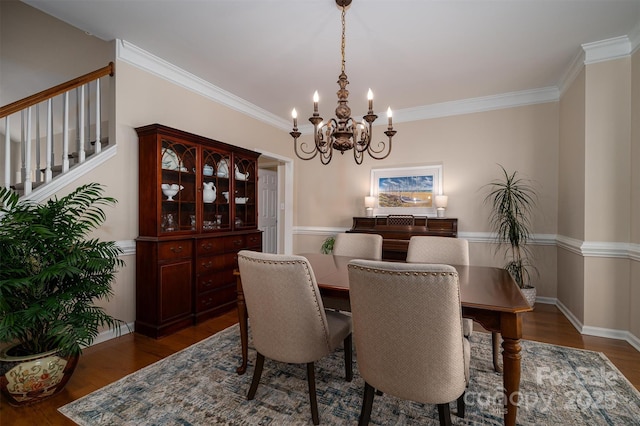 dining area with stairs, crown molding, wood finished floors, and baseboards