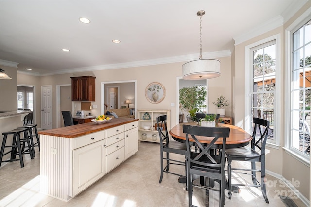 kitchen featuring visible vents, ornamental molding, decorative light fixtures, recessed lighting, and wooden counters