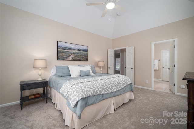 bedroom with a ceiling fan, ensuite bathroom, carpet flooring, baseboards, and vaulted ceiling