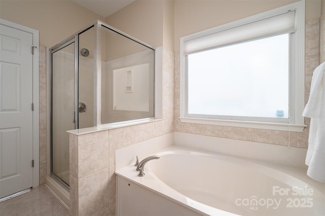 full bath featuring a bath, a shower stall, and tile patterned floors