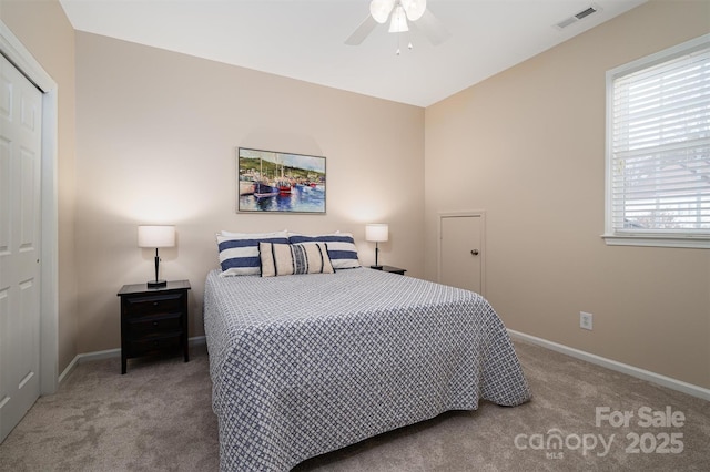 carpeted bedroom featuring visible vents, baseboards, a closet, and ceiling fan