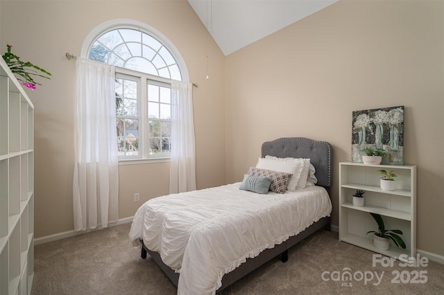 carpeted bedroom with vaulted ceiling and baseboards