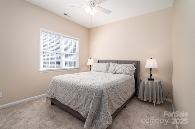 carpeted bedroom featuring visible vents, a ceiling fan, and baseboards