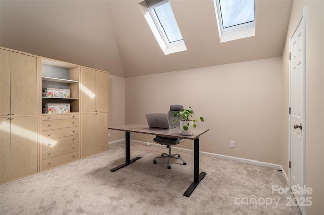 office featuring light colored carpet, baseboards, and lofted ceiling