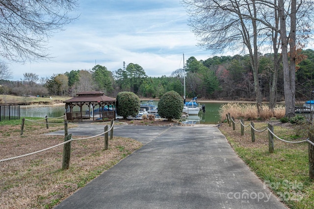 view of road with a water view and driveway