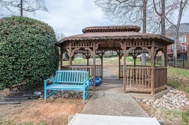 view of home's community with a gazebo, a deck, and fence