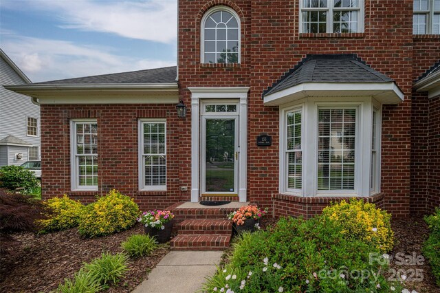 133 Castaway Trl, Mooresville, NC 28117 - view of exterior entry featuring brick siding and a shingled roof