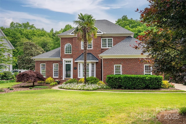 133 Castaway Trl, Mooresville, NC 28117 - colonial inspired home featuring a front yard, a shingled roof, and brick siding