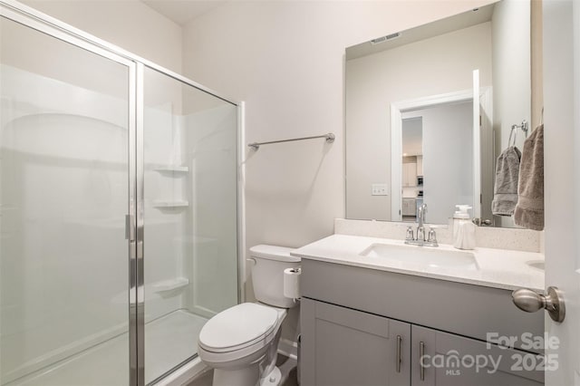 bathroom with vanity, an enclosed shower, and toilet