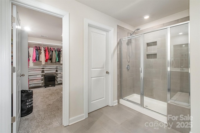 bathroom with tile patterned floors and a shower with shower door