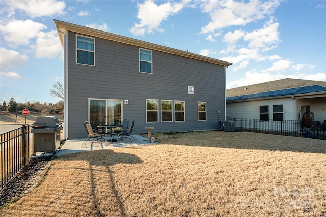 rear view of house with cooling unit and a patio