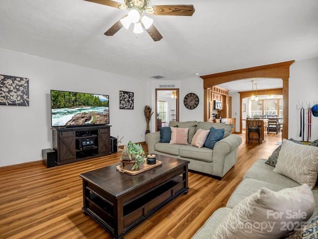 living room featuring light hardwood / wood-style floors and ceiling fan