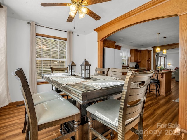 dining area featuring dark hardwood / wood-style floors and ceiling fan