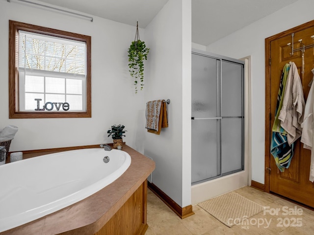 bathroom with shower with separate bathtub and tile patterned flooring