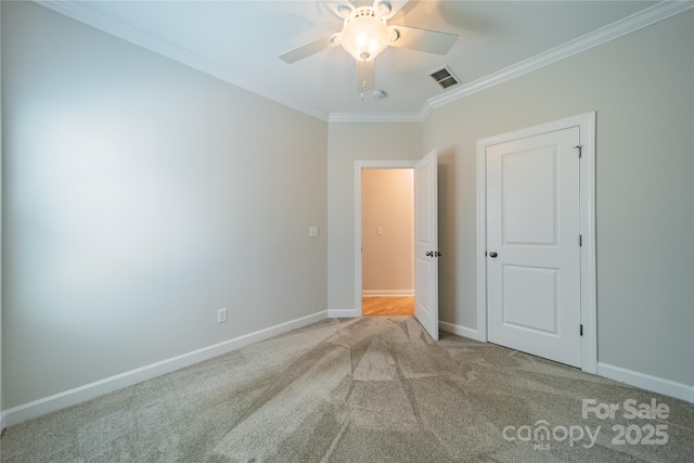 unfurnished bedroom featuring crown molding, light colored carpet, and ceiling fan