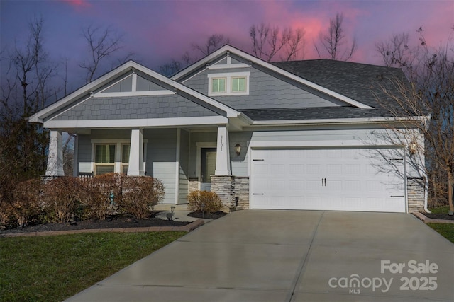 craftsman inspired home featuring a garage and a porch