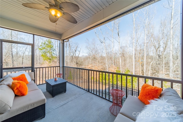 sunroom featuring ceiling fan