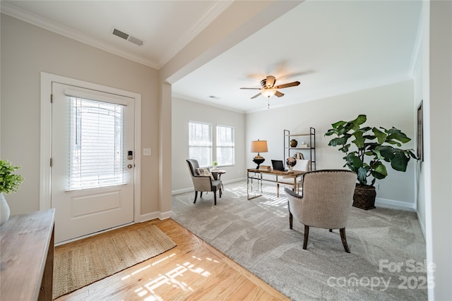 interior space with ornamental molding and ceiling fan