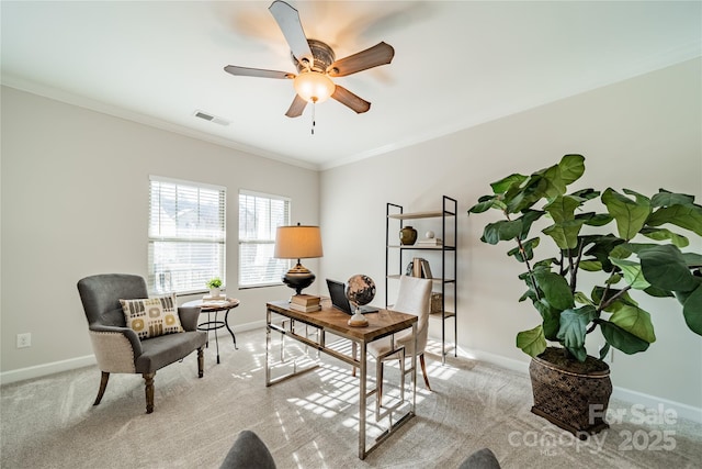 carpeted home office featuring crown molding and ceiling fan