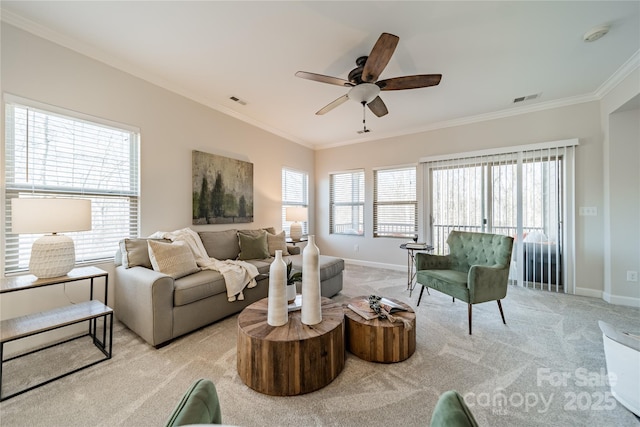 carpeted living room featuring ornamental molding and ceiling fan