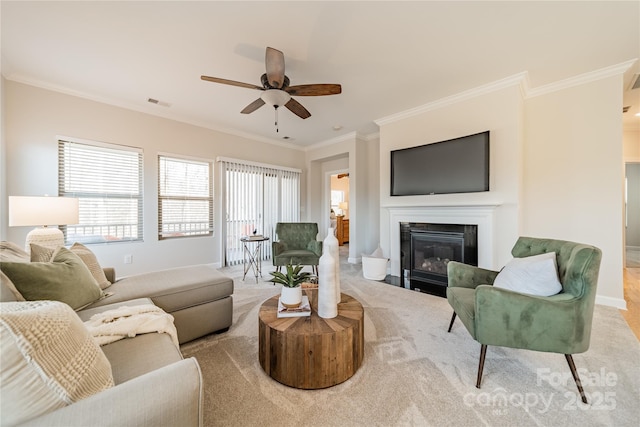 living room with light carpet, ornamental molding, and ceiling fan