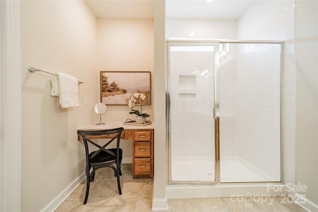 bathroom with an enclosed shower and tile patterned floors