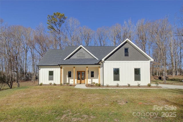 modern farmhouse with a front yard and french doors