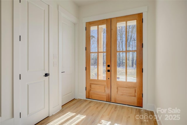 entryway with french doors and light wood-type flooring