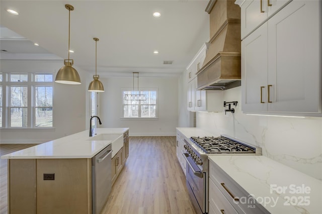 kitchen with a large island, white cabinetry, hanging light fixtures, stainless steel appliances, and custom range hood