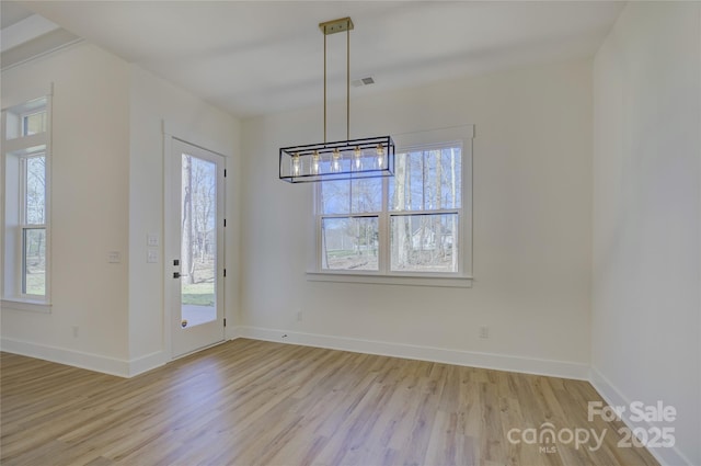 unfurnished dining area featuring light wood-type flooring