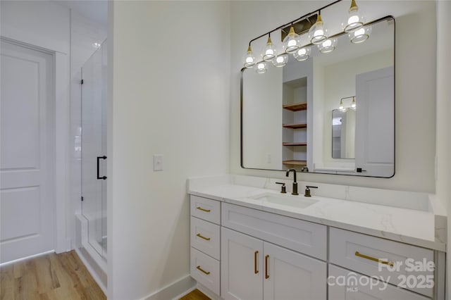 bathroom with vanity, hardwood / wood-style floors, and walk in shower