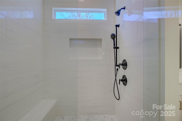 bathroom with tiled shower