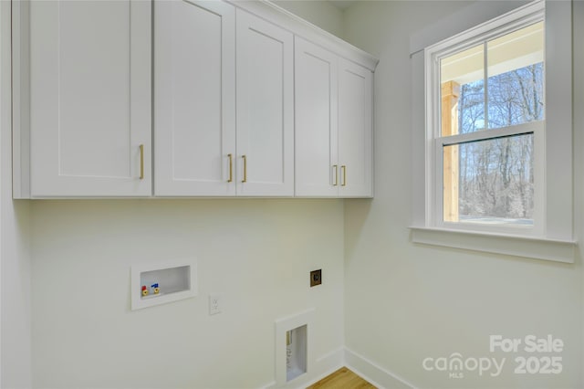 laundry area with cabinets, electric dryer hookup, and hookup for a washing machine