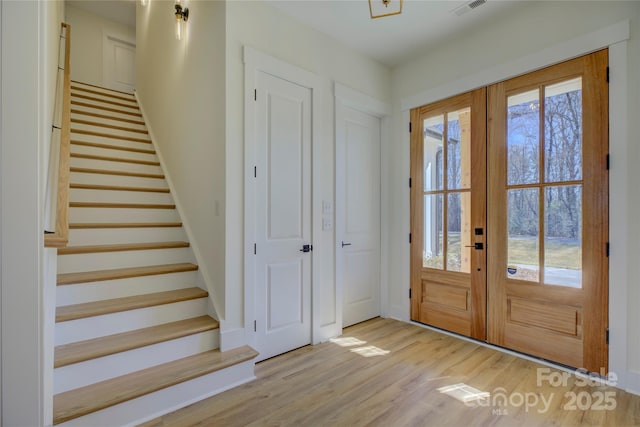 entryway featuring light hardwood / wood-style flooring and french doors