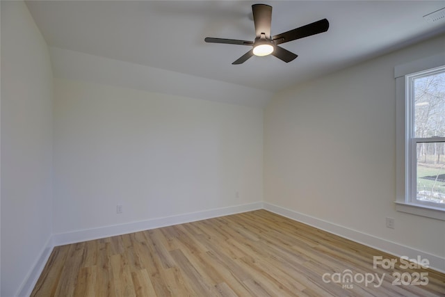 spare room featuring ceiling fan, vaulted ceiling, and light hardwood / wood-style flooring