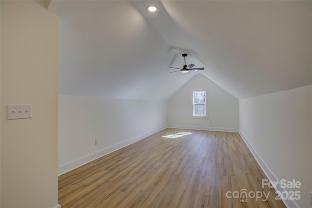 bonus room with lofted ceiling, ceiling fan, and light wood-type flooring