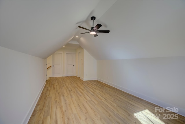 additional living space featuring vaulted ceiling, light hardwood / wood-style floors, and ceiling fan