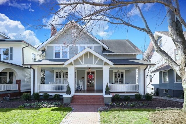 view of front of house featuring a porch and a front yard